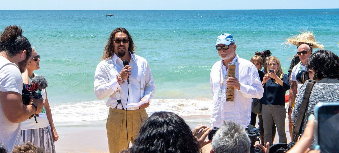 Actor and ocean advocate Jason Momoa (left) and UN Oceans Envoy Peter Thomson (right) on Carcavelos Beach in Lisbon, Portugal, for the nature baton moment at the UN Ocean Summit.