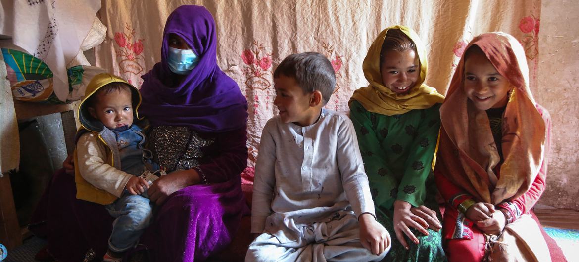 A family sit inside their home, in an informal settlement for internally displaced people in Kabul, Afghanistan.