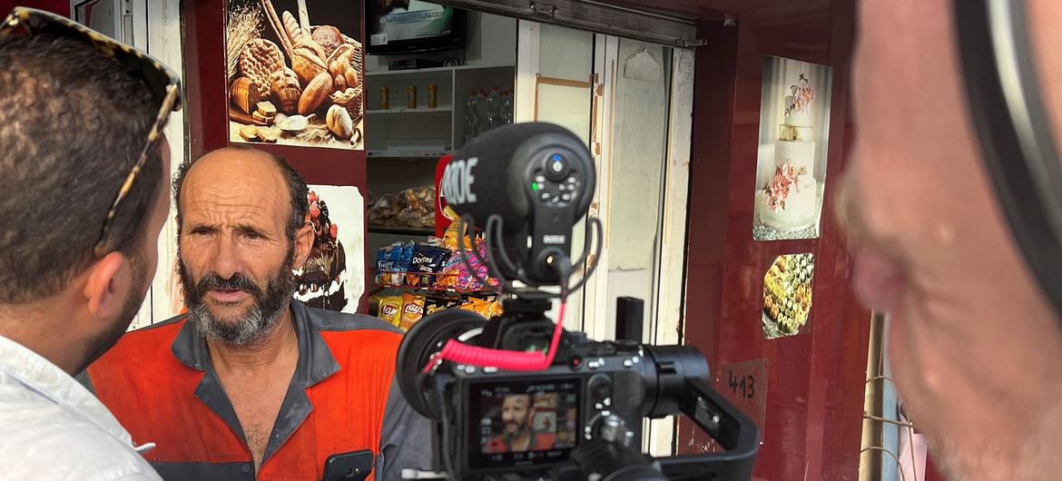 A customer chats with UN News at a Tunis neighbourhood bakery in Ettadhamen.