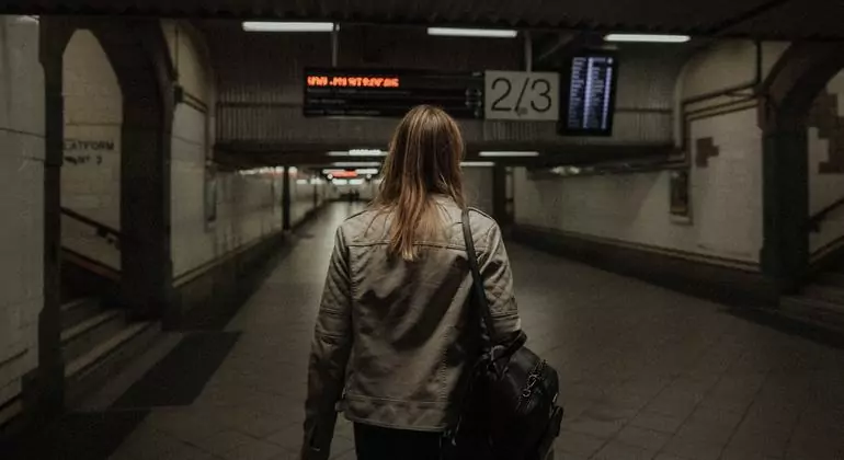 A woman walks through an underground tunnel. A woman walks through an underground tunnel.