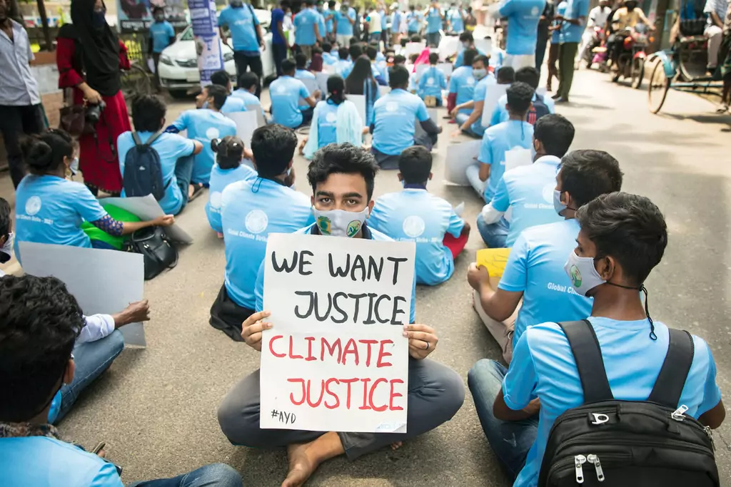 Youth activists sit in the street as a form of strike in solidarity with the Global Climate Strike in Bangladesh. Youth activists sit in the street as a form of strike in solidarity with the Global Climate Strike in Bangladesh.