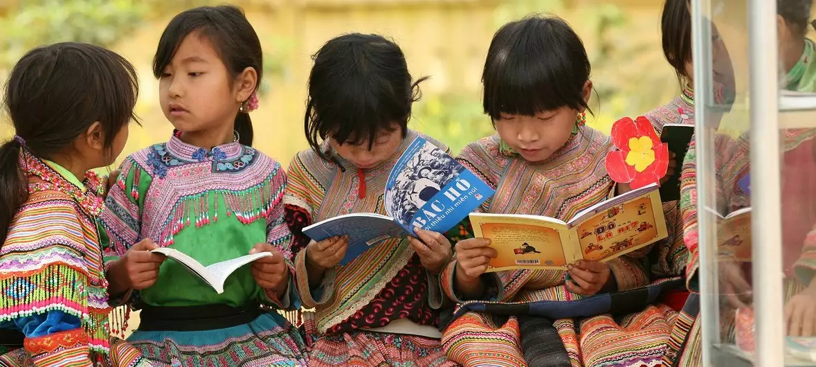 Girls from an indigenous community read outdoors at Ban Pho Primary School in Bac Han District in remote Lao Cai Province, Viet Nam. Girls from an indigenous community read outdoors at Ban Pho Primary School in Bac Han District in remote Lao Cai Province, Viet Nam.