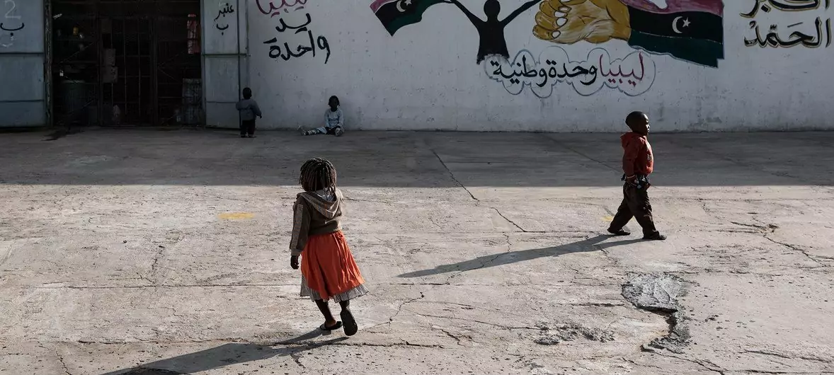Migrant children walk outside a detention centre located in Tripoli, Libya. Migrant children walk outside a detention centre located in Tripoli, Libya.