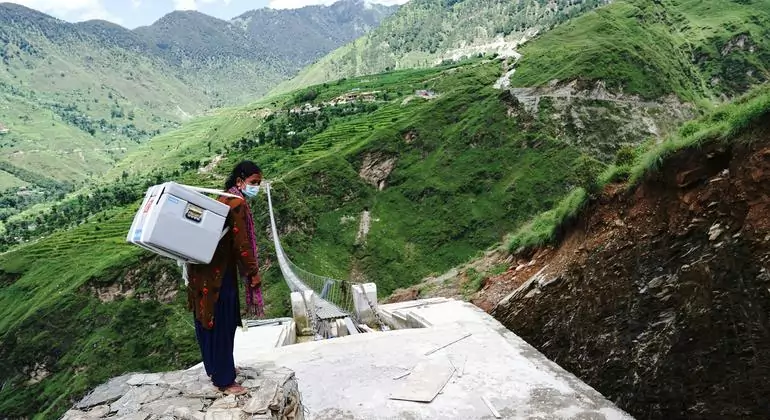A health worker delivers COVID-19 vaccines, donated through the COVAX Facility, to a Health Post in Nepal A health worker delivers COVID-19 vaccines, donated through the COVAX Facility, to a Health Post in Nepal