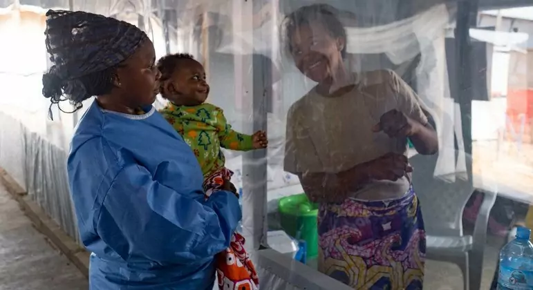 A plastic sheet separates a mother from her son at an Ebola treatment centre in Beni, North Kivu province, Democratic Republic of the Congo. A plastic sheet separates a mother from her son at an Ebola treatment centre in Beni, North Kivu province, Democratic Republic of the Congo.
