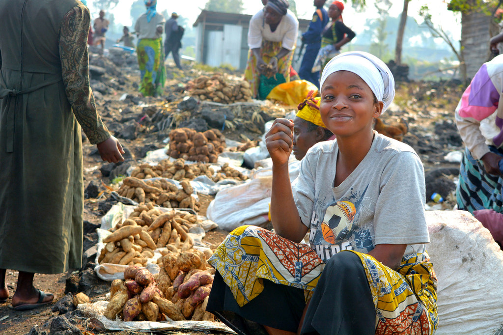 A woman sells food at a market in the Democratic Republic of the Congo.