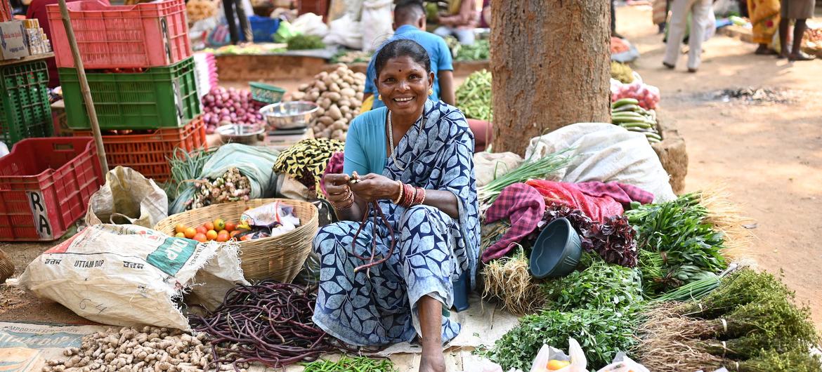 A woman from a tribal community selling forest produce at a local market in India.